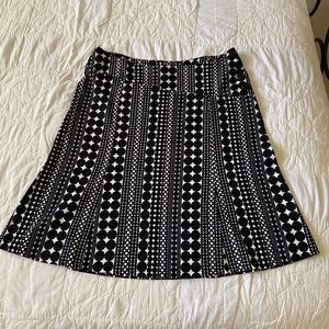Cool & crisp black & white print skirt. Angled band with 4 big buttons. Size 14